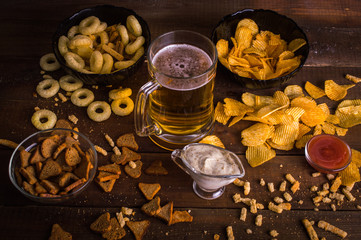 Beer and snacks on the wooden background