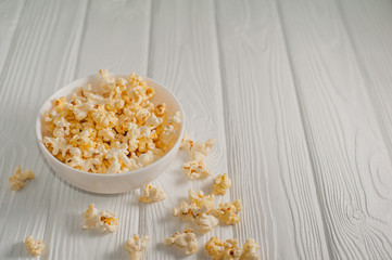 popcorn on a white wooden background