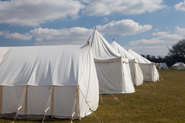 Vintage wall tents, Napoleonic war white cotton military camp tents. Historical officers camping