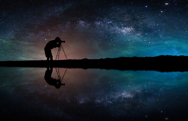 Fototapeta premium Landscape with Milky way galaxy. Night sky with stars and silhouette Photographer take photo on the mountain.