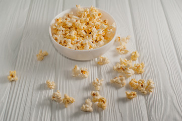 popcorn on a white wooden background