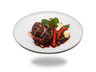 Spicy raw beef salad with chilli, garlic and mint leaf Thailand local food isolated on white background.
