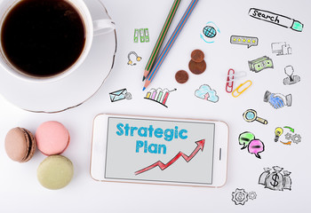 Naklejka premium Strategic Plan Concept. Mobile phone and coffee cup on a white office desk