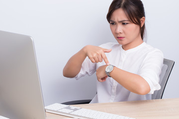 Angry woman checking time at office