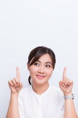 Asian woman pointing to the copy space isolated on blue background