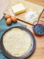 Top view of the ingredients for making traditional thin pancakes.