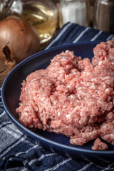 Minced meat on wooden background.