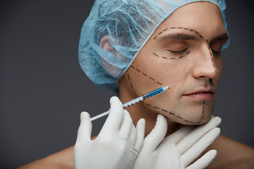 Male Face Beauty Injections. Handsome Man Getting Skin Injection