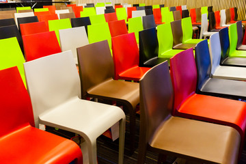 Fototapeta premium Colorful chairs arranged in a meeting room.