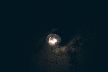 Electric lamp on a background of a clay wall