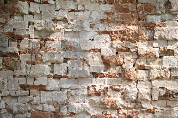 Background and texture of old vintage dirty brick wall with peeling plaster