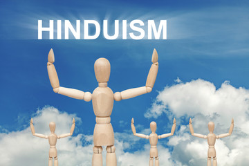 Wooden dummy puppet on sky background with text INDUISM