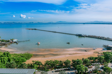 Pier with long bridge lay into the sea.