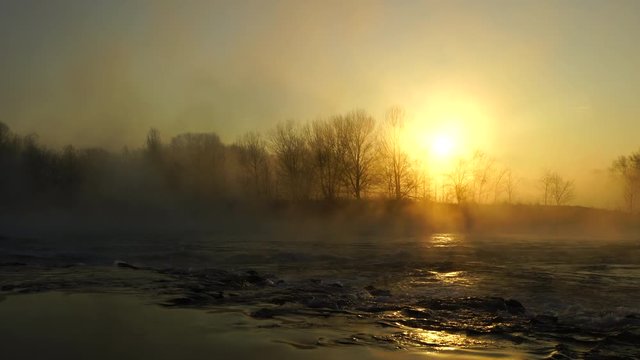 Sunrise at foggy river