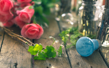 The branches in a glass jar on the background of flower on the wooden