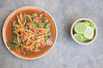 Spicy cockle salad with fresh vegetable on dish.