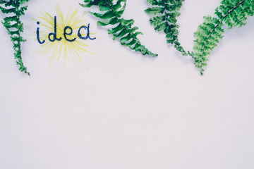 The inscription on a white background with the leaves of plants