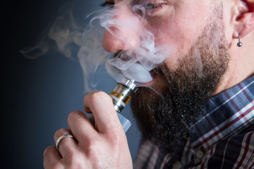 beared man  smoking electronic cigarette