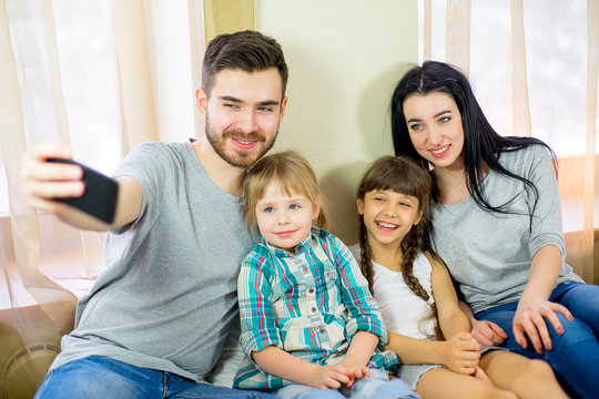 selfie family makes sitting on the bed