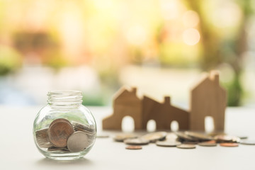 Coins in glass jar for money saving for housing,financial concept