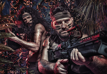 Colorful portrait of a two serious soldiers fighting in the jungle