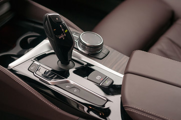 Automatic gear shift lever and infotainment system controls.