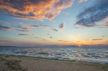 Fototapeta na wymiar Beautiful, a burning cloudy sky above the sea, dawn