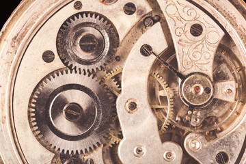 Fototapeta na wymiar Close-up of old clock rusty mechanism with gears. Vintage toned