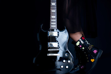 Obraz na płótnie Canvas Close up of girl's legs and guitar.