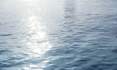 Water surface with ripples and sunlight reflections