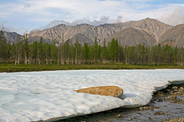 The remnants of last year the ice in the valley of the creek. Omulewska the Midlands. Yakutia....