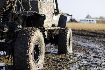 Off-road car in a puddle making mud splashes.