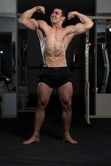 Bodybuilder Fitness Model Posing Double Biceps After Exercises