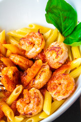Shrimp salad with cherry tomatoes and natural condiment in a white bowl.