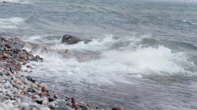 waves crash along a rocky shore