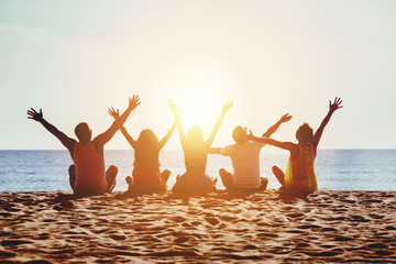 Group happy people beach sea sunset concept - Powered by Adobe
