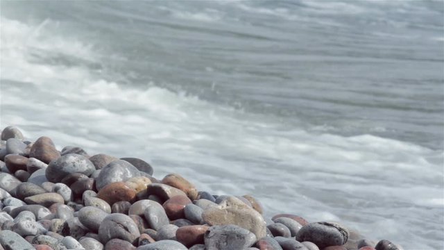 waves crash along a rocky shore