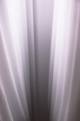 Obraz premium Vertical creases and folds on a fabric with highlight and shadows