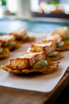 Tostones with abocado and fried cheese