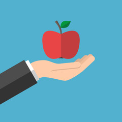 Hand holding red apple