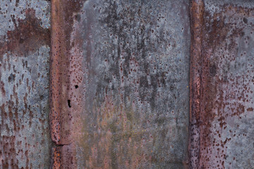 Backdrop of the barn covered with old rusty tin sheets and slate, background