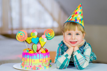 little girl celebrates birthday with cake