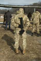 A soldier standing with a gun behind his back