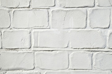 Decorative white stucco imitating brick wall