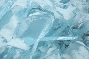transparent pieces of ice on the surface of the iced nad snowcaped pond. Baikal lake. Photo toned