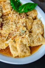 Ravioli with bacon cheese and white sauce.