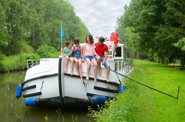 Family vacation, travel on barge boat in canal, happy kids having fun on river cruise trip in...