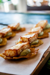 Tostones with abocado and fried cheese