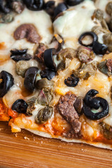 Organic Homemade pizza with mushrooms in a wood table.