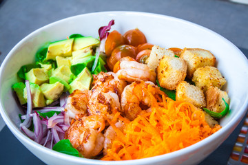 Shrimp salad with abocado in a white bowl
